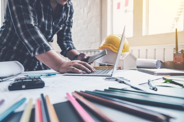 Engineer man working in the office, Drawing the construction project.